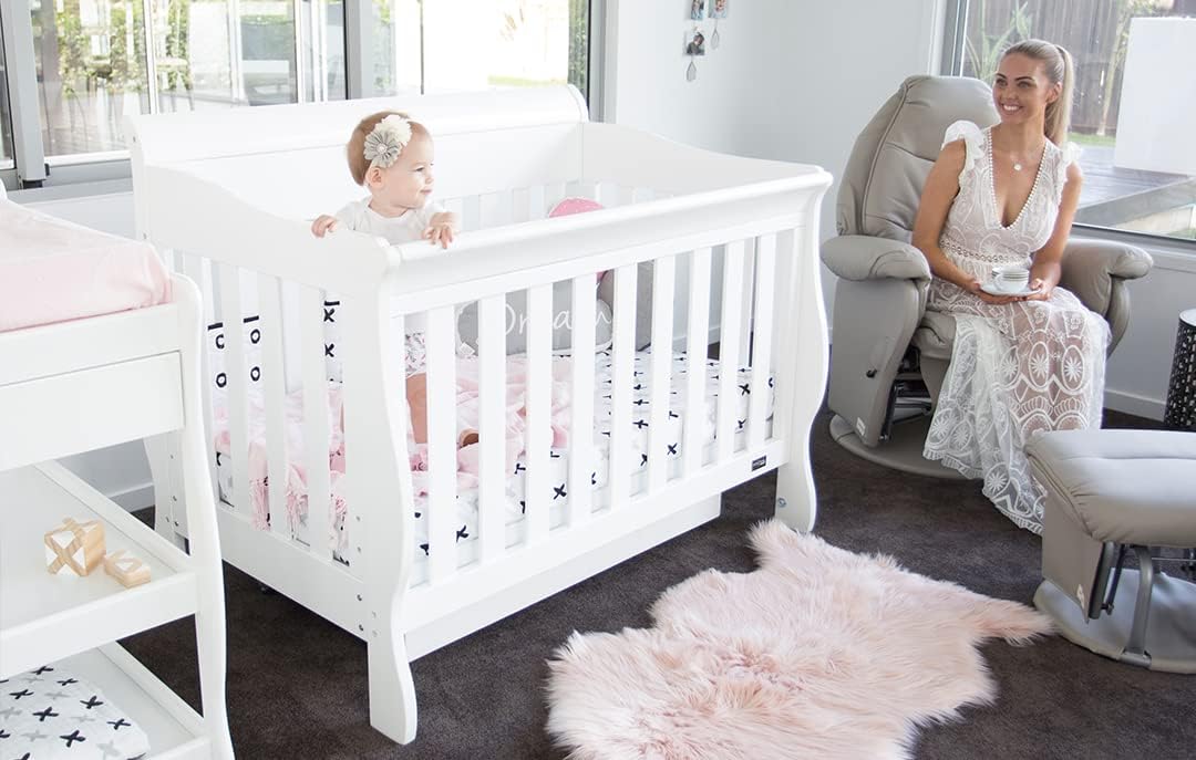 Babyhood Amani Sleigh Cot - White Grows with your child, as the base levels adjust from bassinet, to cot and to toddler bed